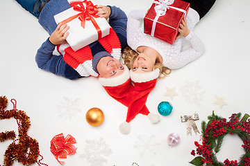 Image showing Lovely christmas couple lying with presents