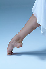 Image showing Close-up ballerina\'s leg on the blue floor 