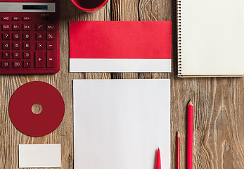 Image showing The mockup on wooden background with red calculator