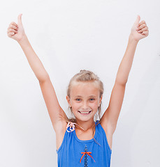 Image showing Portrait of a beautiful girl showing thumbs up on white