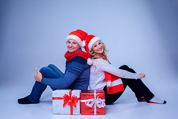 Image showing Lovely christmas couple sitting with presents