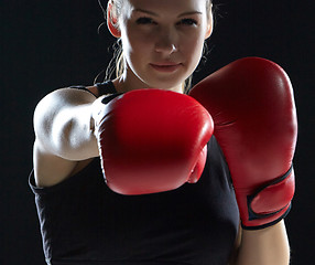 Image showing beautiful woman is boxing on gray background