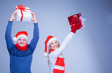 Image showing Lovely christmas couple holding presents