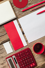 Image showing The mockup on wooden background with red calculator