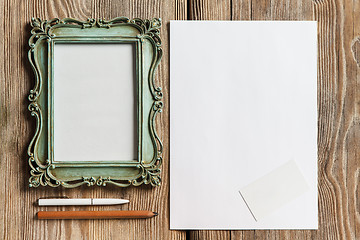 Image showing The mockup on wooden background with vintage old picture frame