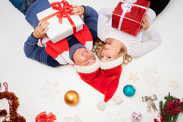 Image showing Lovely christmas couple lying with presents