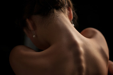 Image showing Beautiful woman, back view on dack background