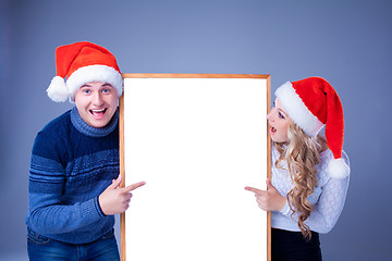 Image showing Christmas couple holding white board with empty copy space 