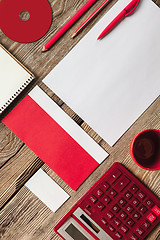 Image showing The mockup on wooden background with red calculator