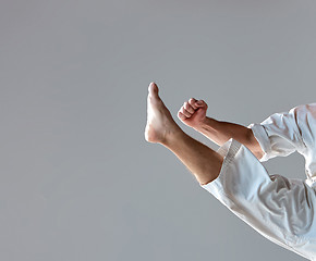 Image showing Man in white kimono training karate