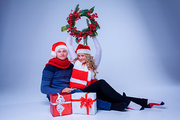 Image showing Lovely christmas couple sitting with presents