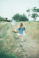 Image showing The young mother and daughter on green grass background 