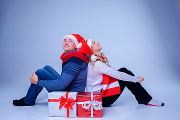 Image showing Lovely christmas couple sitting with presents