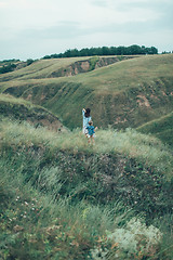 Image showing The young mother and daughter on green grass background 