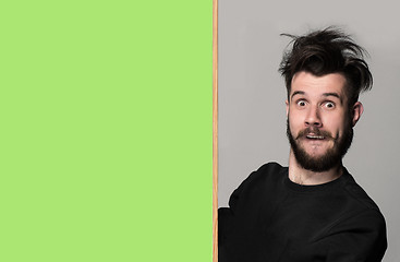 Image showing The surprised man and empty blank over gray background