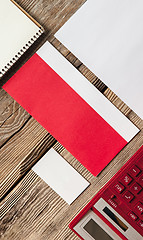 Image showing The mockup on wooden background with red calculator