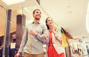 Image showing happy young couple with shopping bags in mall