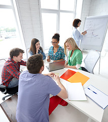 Image showing group of happy high school students with workbook