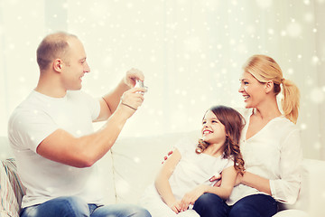 Image showing happy family with camera taking picture at home