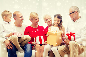Image showing smiling family with gifts at home