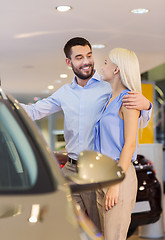 Image showing happy couple buying car in auto show or salon