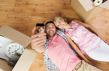 Image showing couple with big cardboard boxes moving to new home