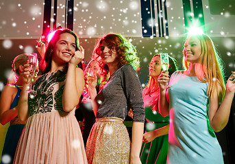 Image showing smiling friends with glasses of champagne in club