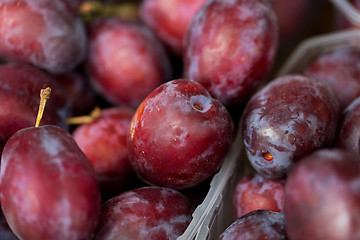 Image showing close up of satsuma plums in box at street market