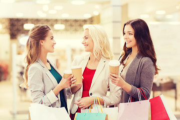 Image showing young women with shopping bags and coffee in mall