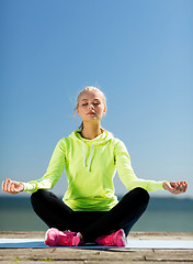 Image showing woman doing yoga outdoors