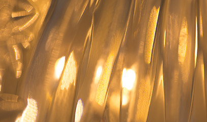 Image showing lights reflection on golden metallic background