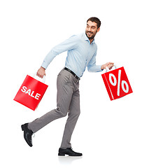 Image showing smiling man with red shopping bag