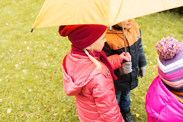 Image showing close up of kids with umbrella in autumn park