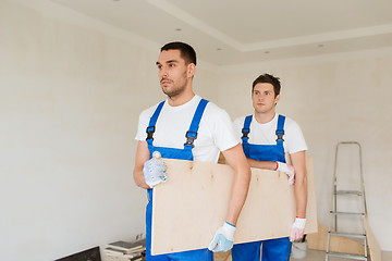 Image showing group of builders with wooden boards