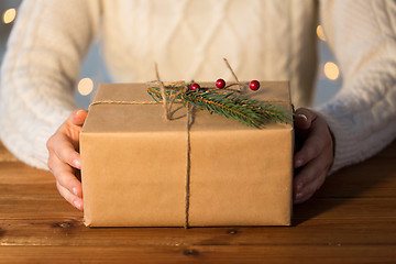 Image showing close up of woman with christmas gift or parcel