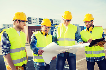 Image showing group of builders with tablet pc and blueprint