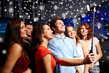 Image showing friends with smartphone taking selfie in club