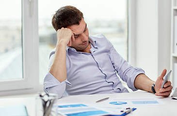 Image showing  businessman with smartphone  at office 