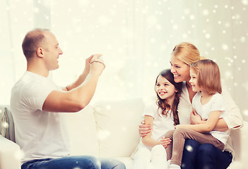 Image showing happy family with camera taking picture at home