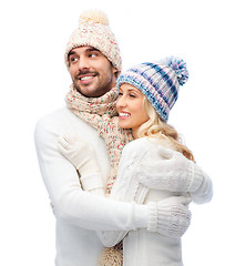Image showing smiling couple in winter clothes hugging