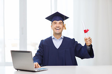 Image showing smiling adult student in mortarboard with diploma