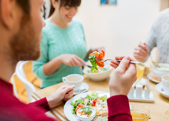 Image showing close up friends having dinner at restaurant