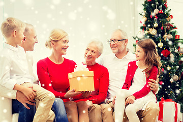 Image showing smiling family with gifts at home