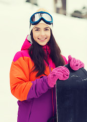 Image showing happy young woman with snowboard outdoors