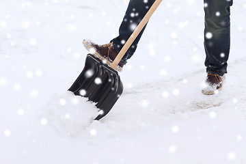 Image showing closeup of man digging snow with shovel