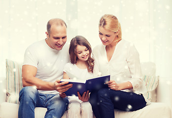 Image showing happy family with book at home