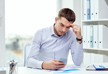 Image showing close up of businessman with smartphone