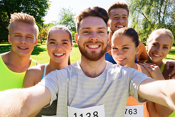 Image showing happy friends taking selfie with smartphone