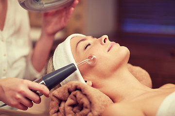 Image showing close up of young woman having face massage in spa