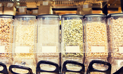 Image showing row of jars with nuts and seeds at grocery store